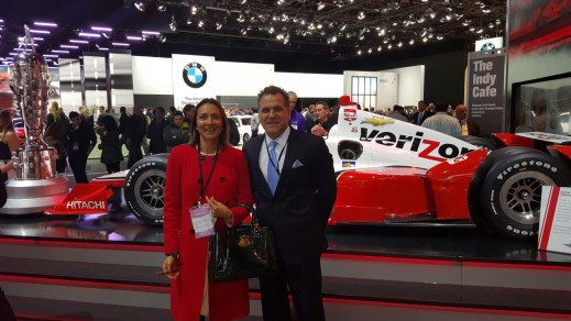Vanessa and John pose in front of the Verizon IndyCar Series display with Juan Pablo Montoya's 2015 Indianapolis 500-winning car. 
