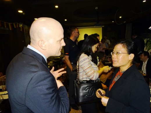 Melania Wu (right), HCP Head of Beijing Office, chats with a member of the audience after the presentations in Beijing. 